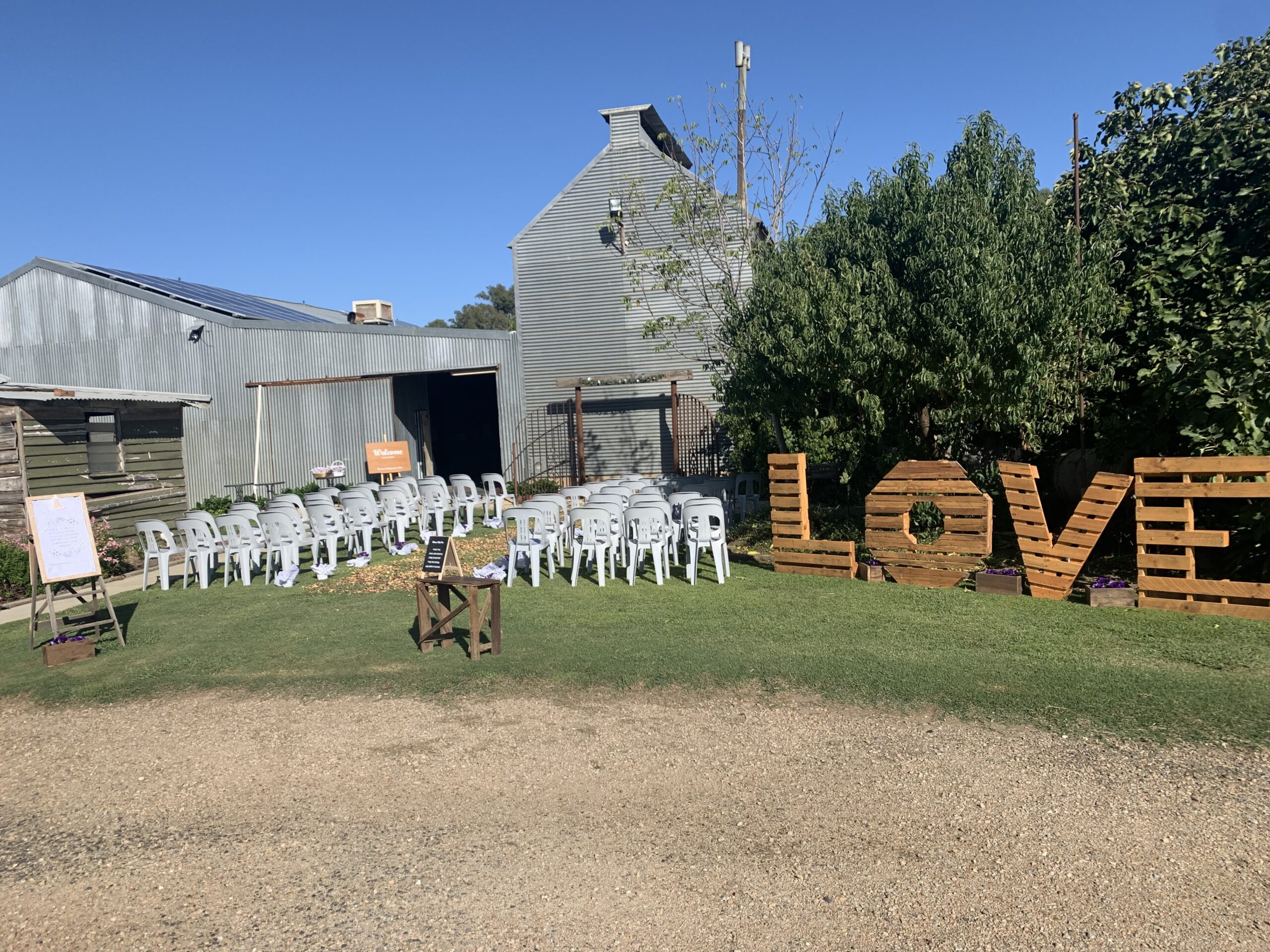 The shed from outside with the ceremony set up on the lawn