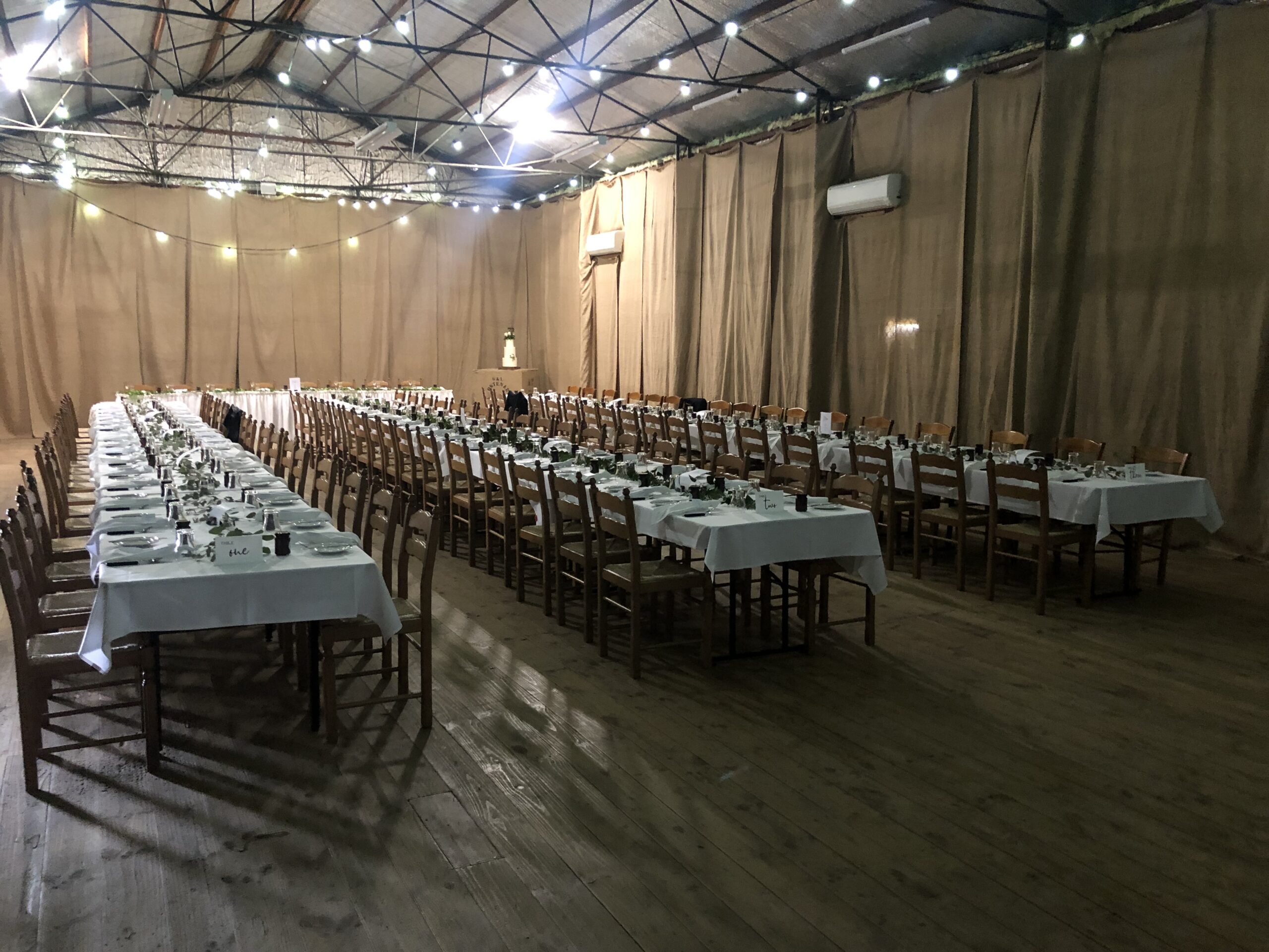 Banquet tables set in the shed, daylight