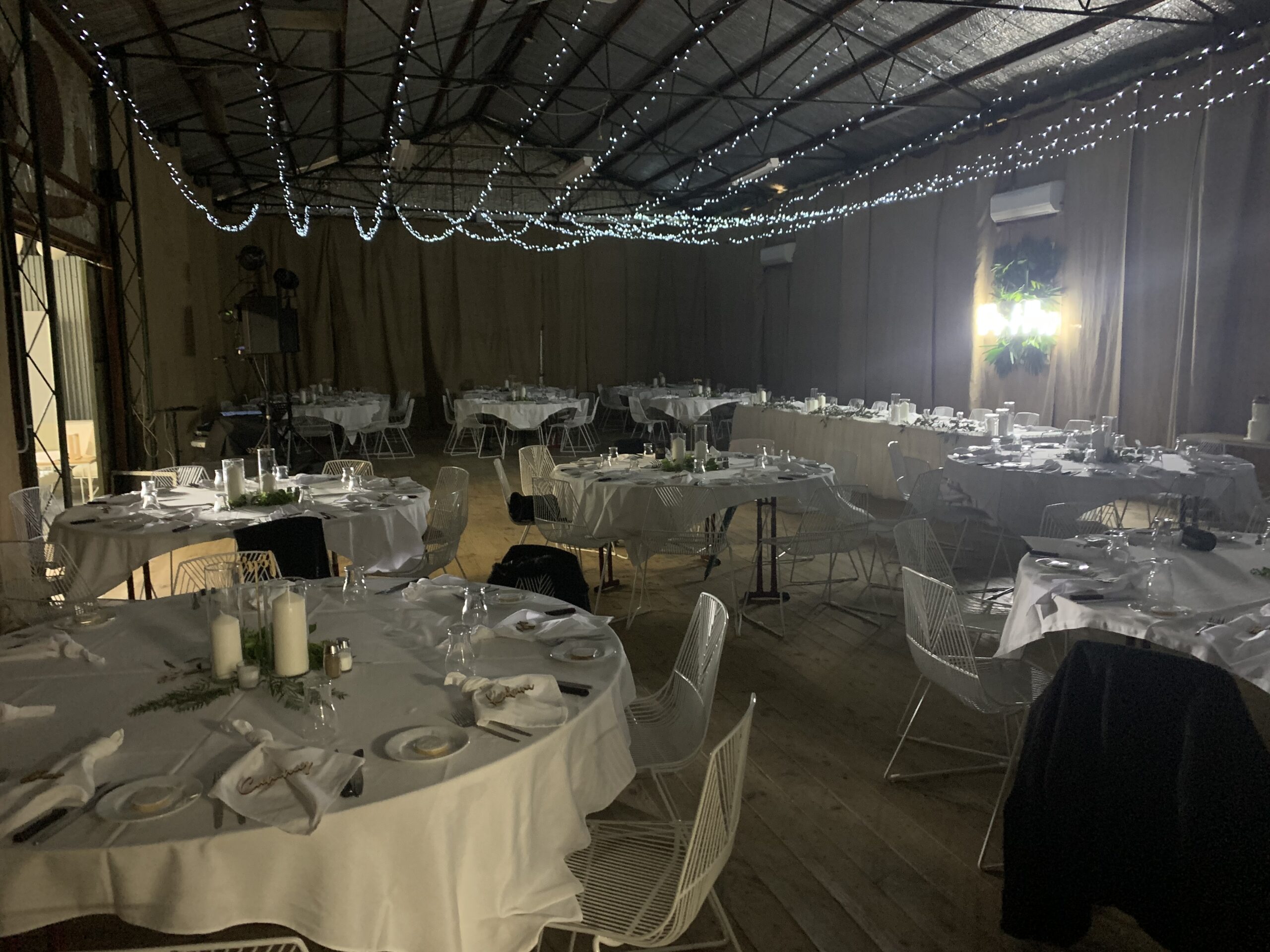 The shed at night under festoon lights